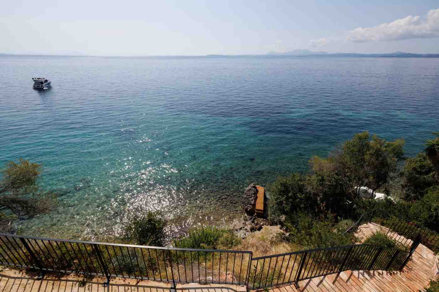 Luxury 260 sq.m. beachfront villa for sale in Corfu with private pool, garden, direct beach access, and panoramic sea views.